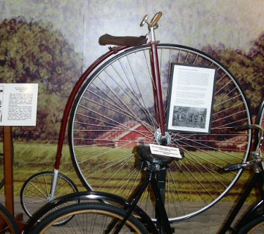 [Early bike with large front tire and small rear tire.]